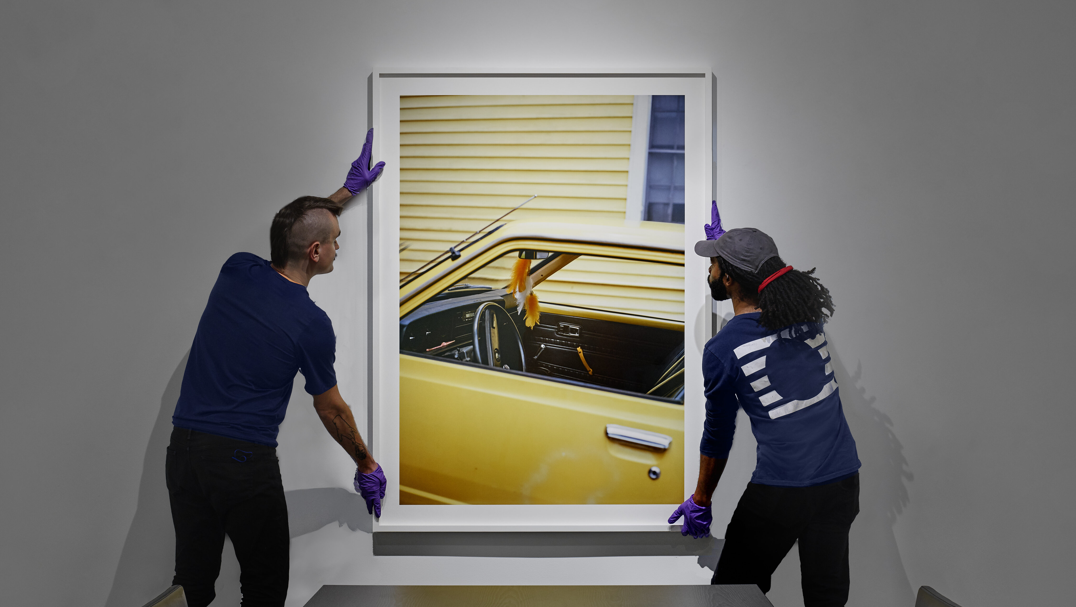 UOVO Staff Hanging Artwork on Wall