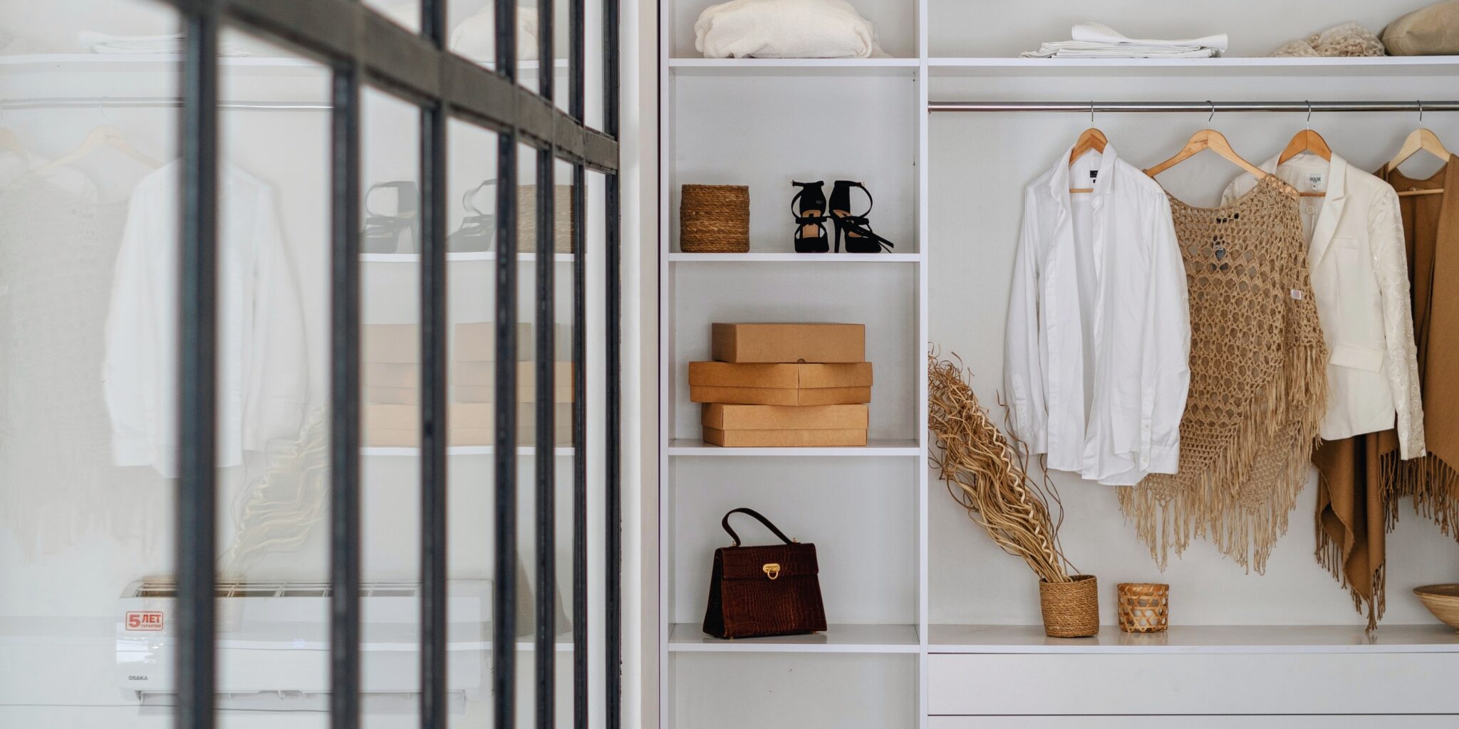 closet interior with clothing, boxes, and accessories
