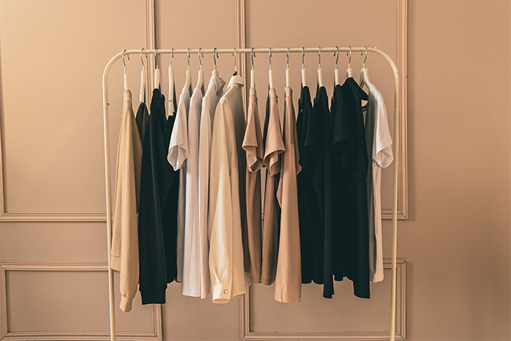 Clothing on a rack prepared for UOVO Fashion’s professional garment storage.