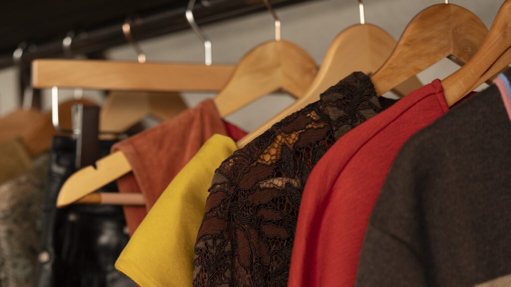 Garments on wooden hangers, prepared for storage at the UOVO Fashion facility.