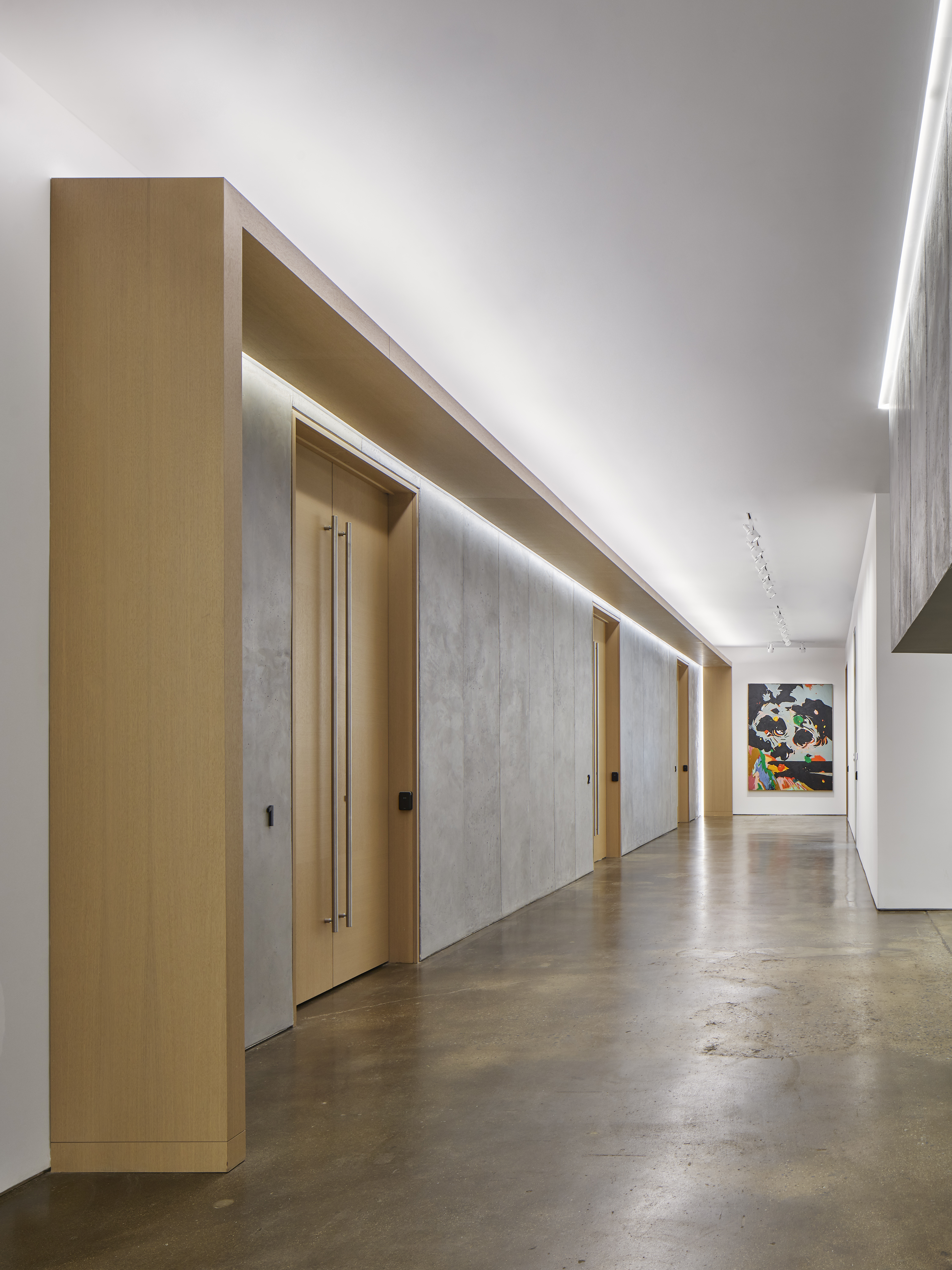 UOVO Facility Hallway with Doors and Artwork on Wall