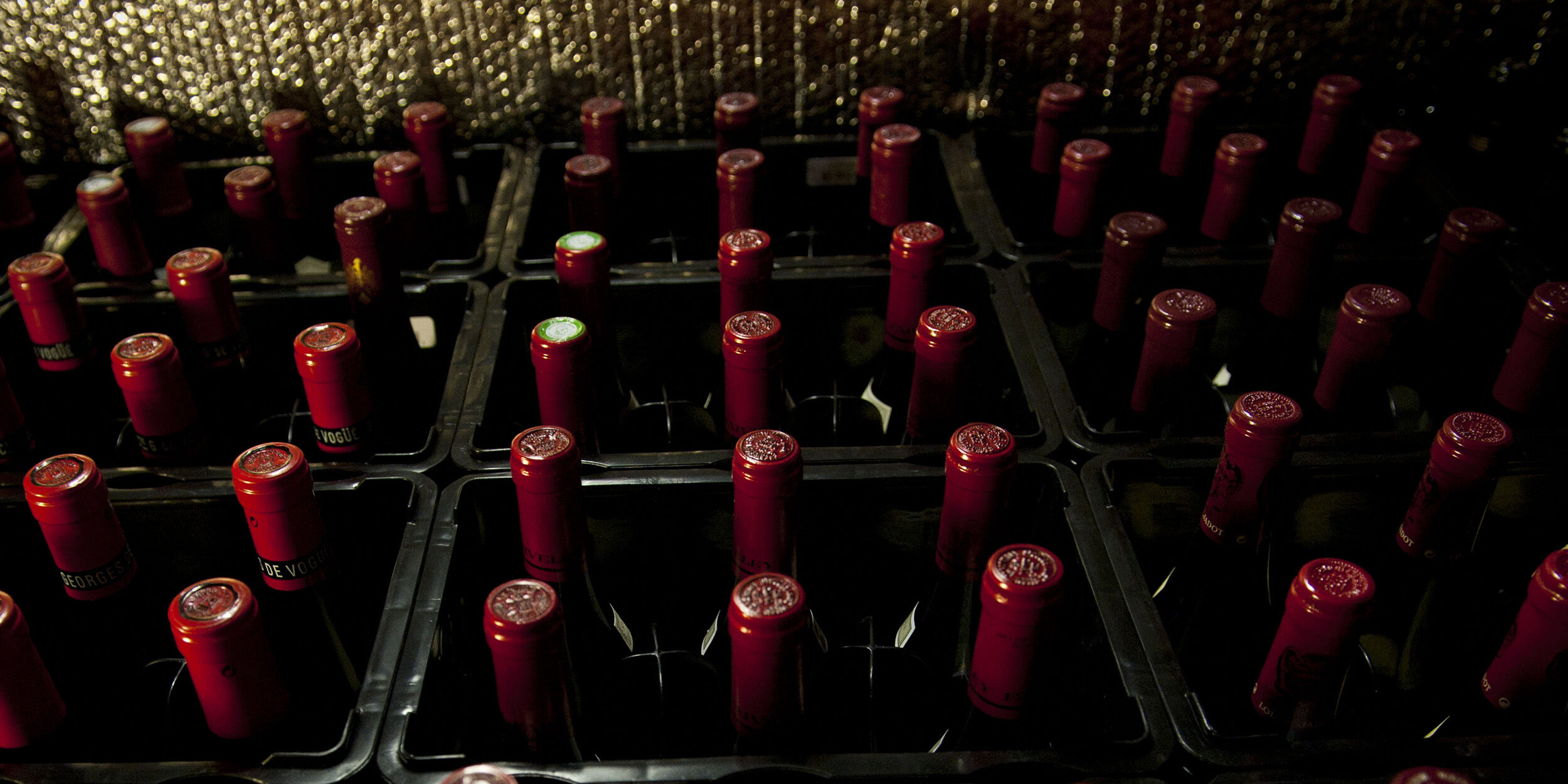 UOVO Wine storage crates filled with red-capped wine bottles, ensuring secure and professional storage.