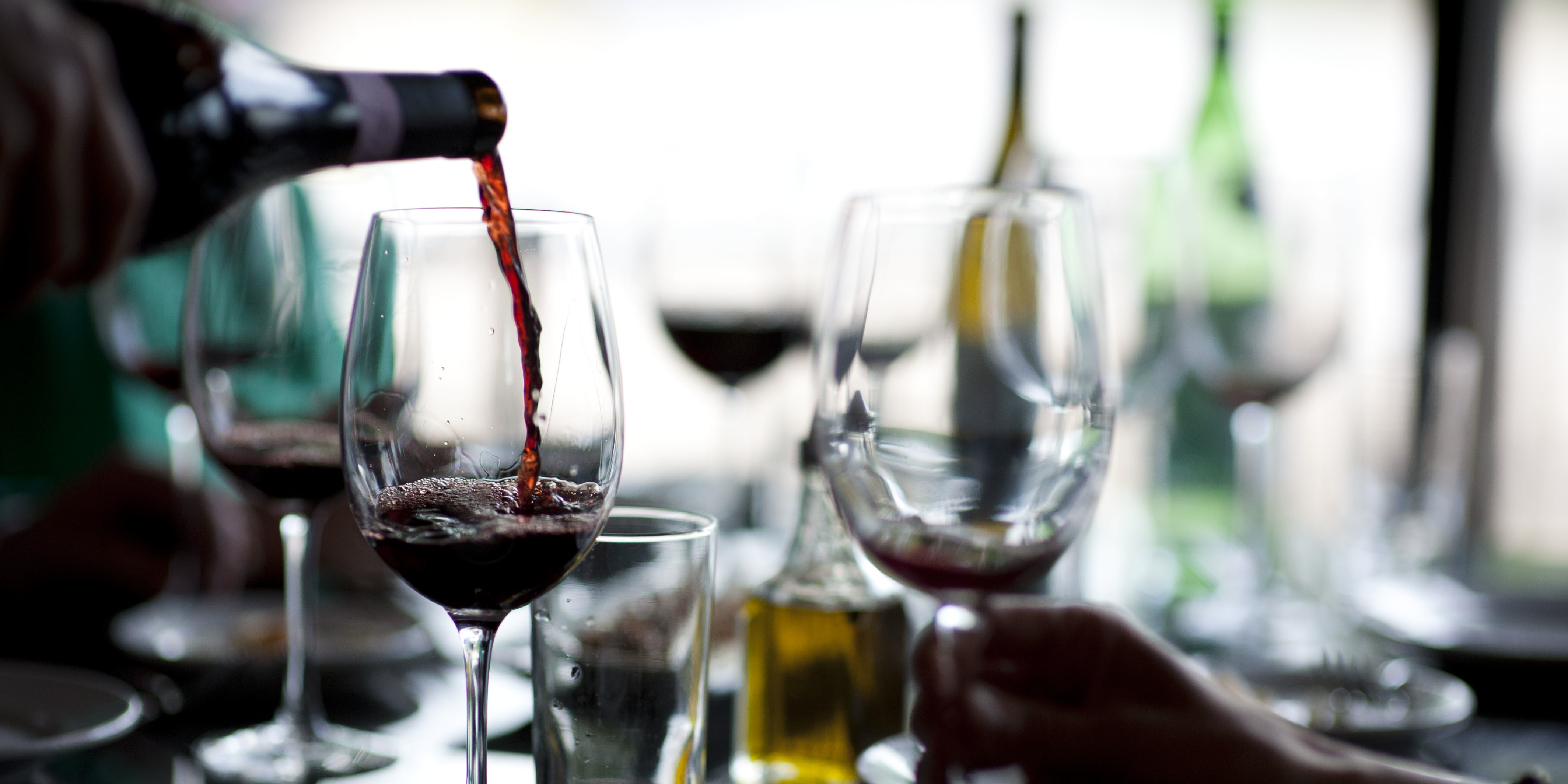 Pouring Wine into Wine Glasses