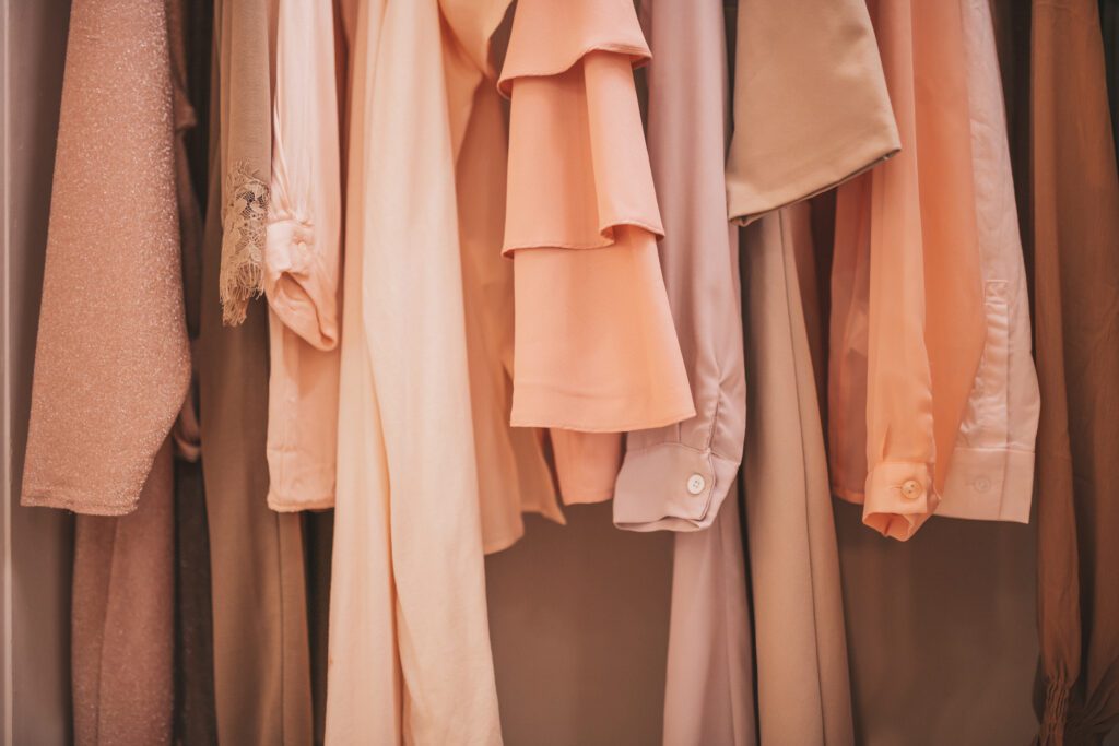 UOVO Fashion storage rack of luxury vintage clothing pieces awaiting archival.