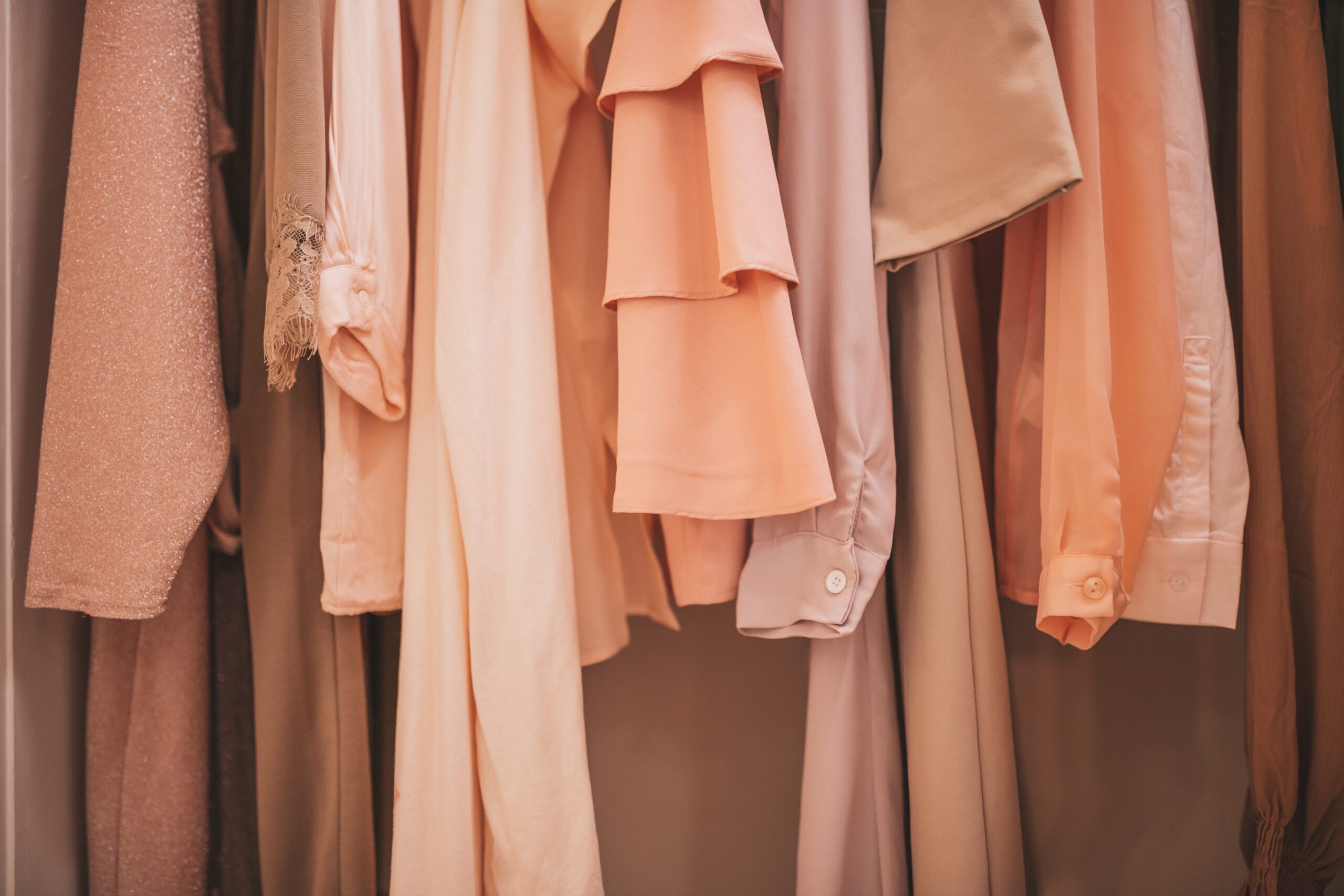 UOVO Fashion storage rack of luxury vintage clothing pieces awaiting archival.