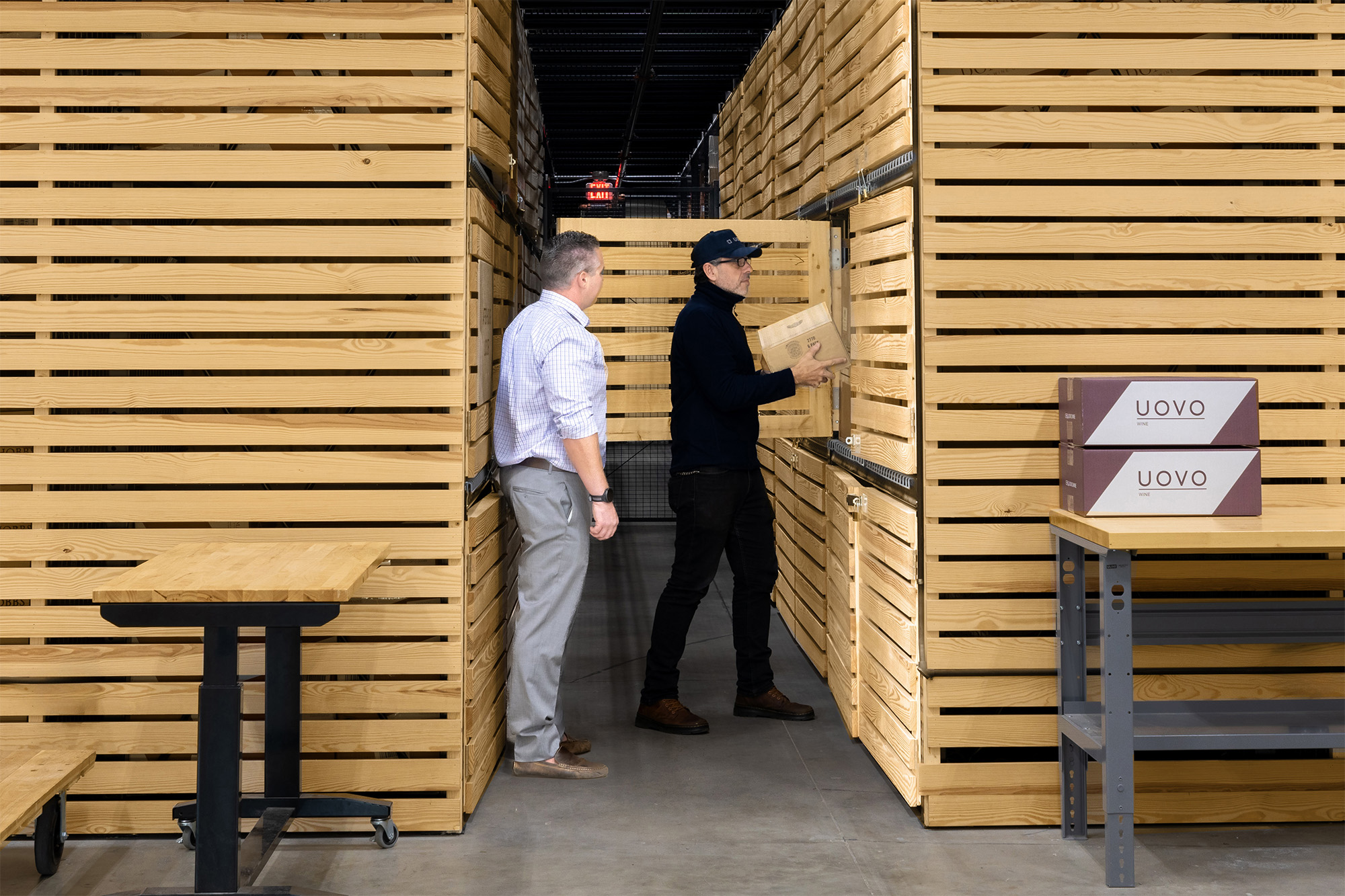 People Putting Wine Crates into UOVO Wine Storage Units