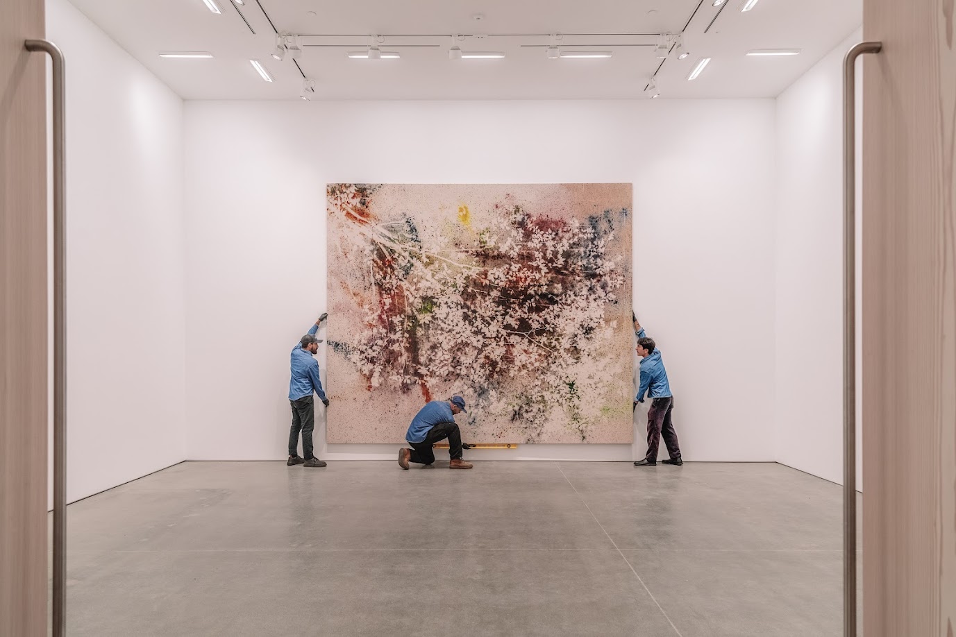 UOVO Art Handlers installing a large painting.