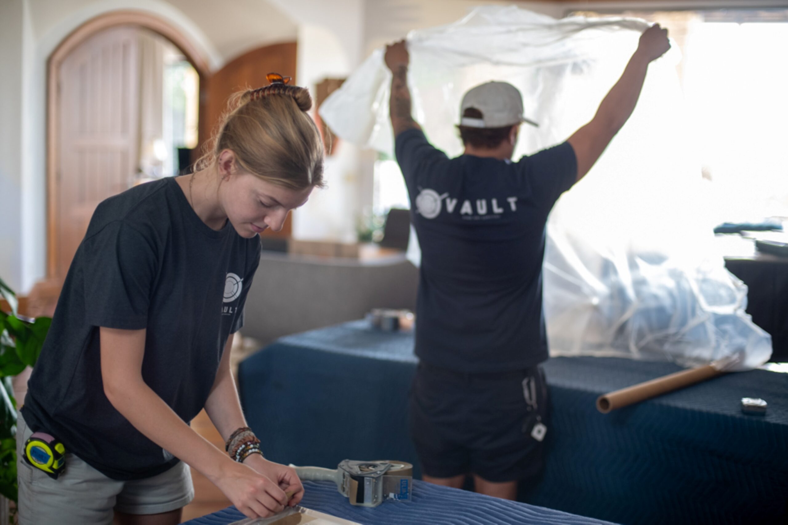 Vault Fine Art team members carefully working on a project