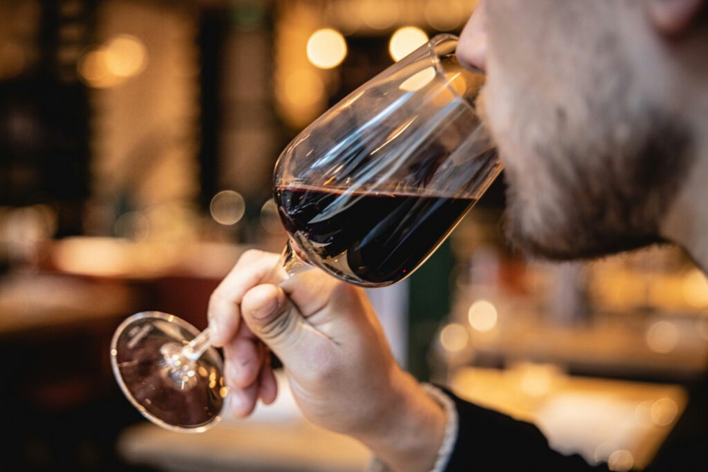 Wine collector with a glass of red wine.